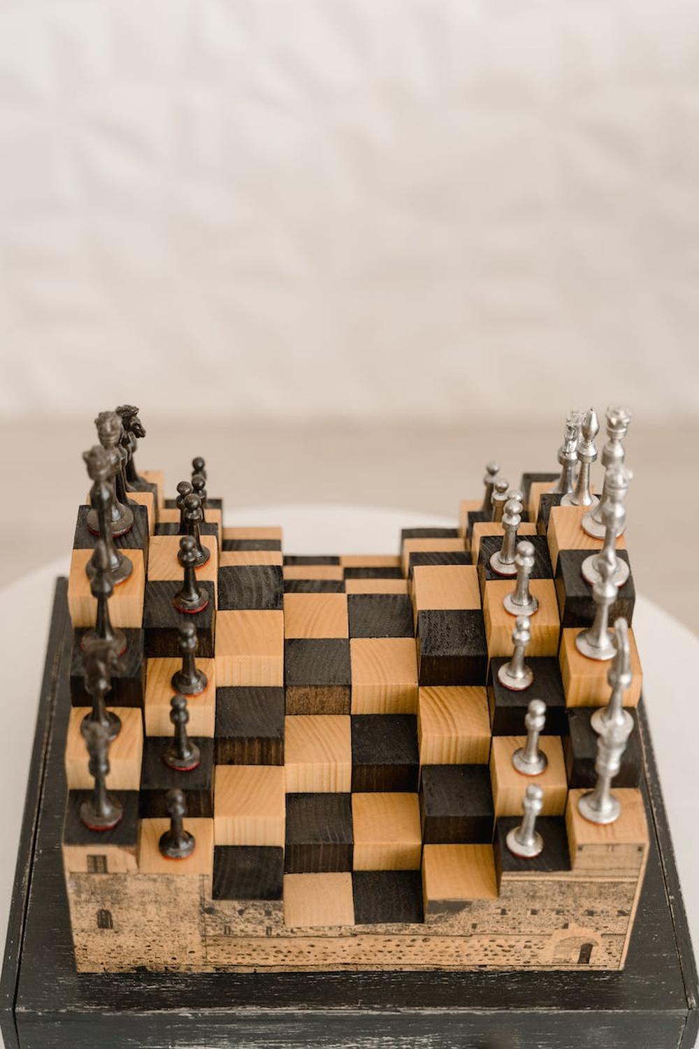 a_unique_metal_chess_set_on_a_white_table