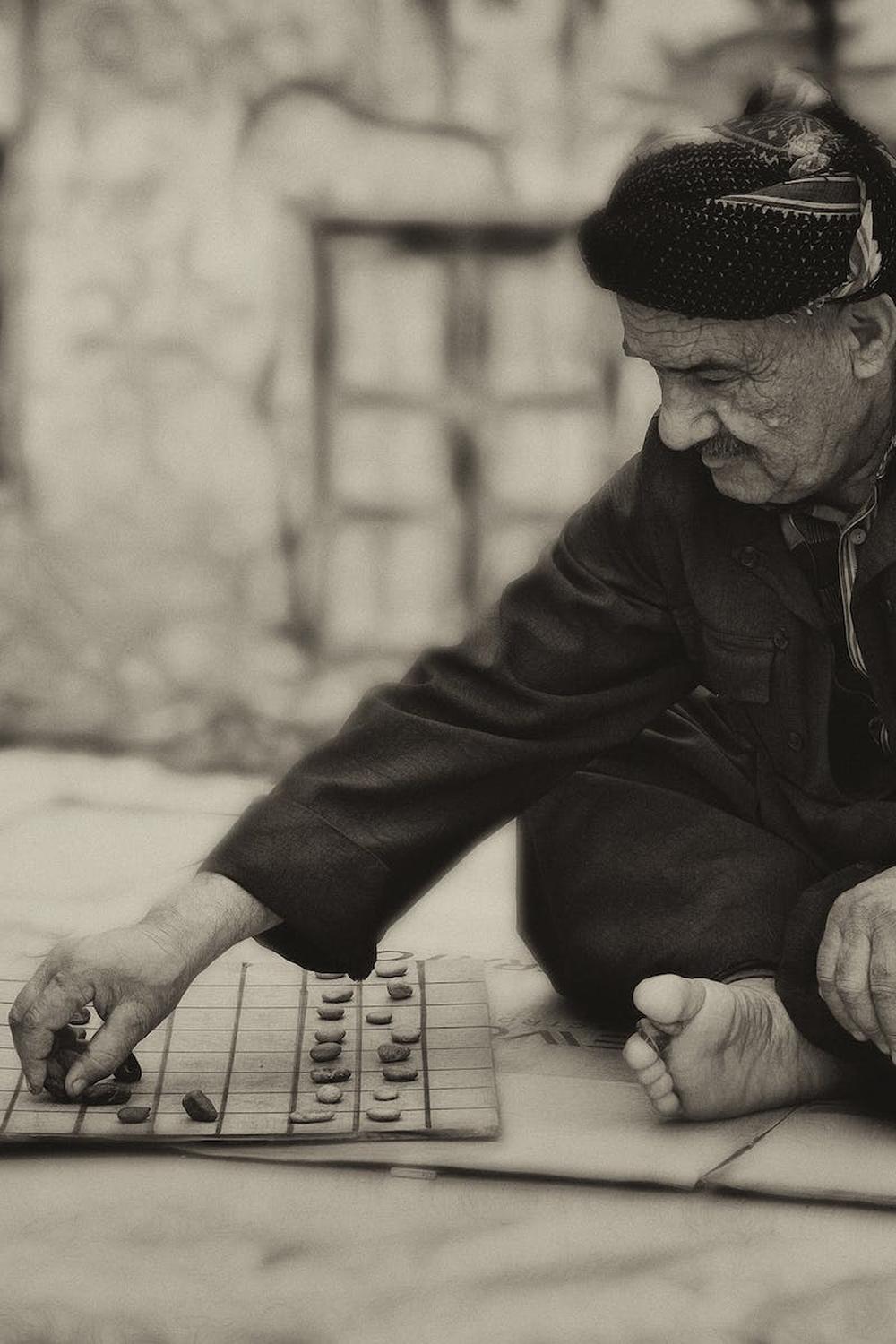 man_in_cross_sitting_position_outdoors