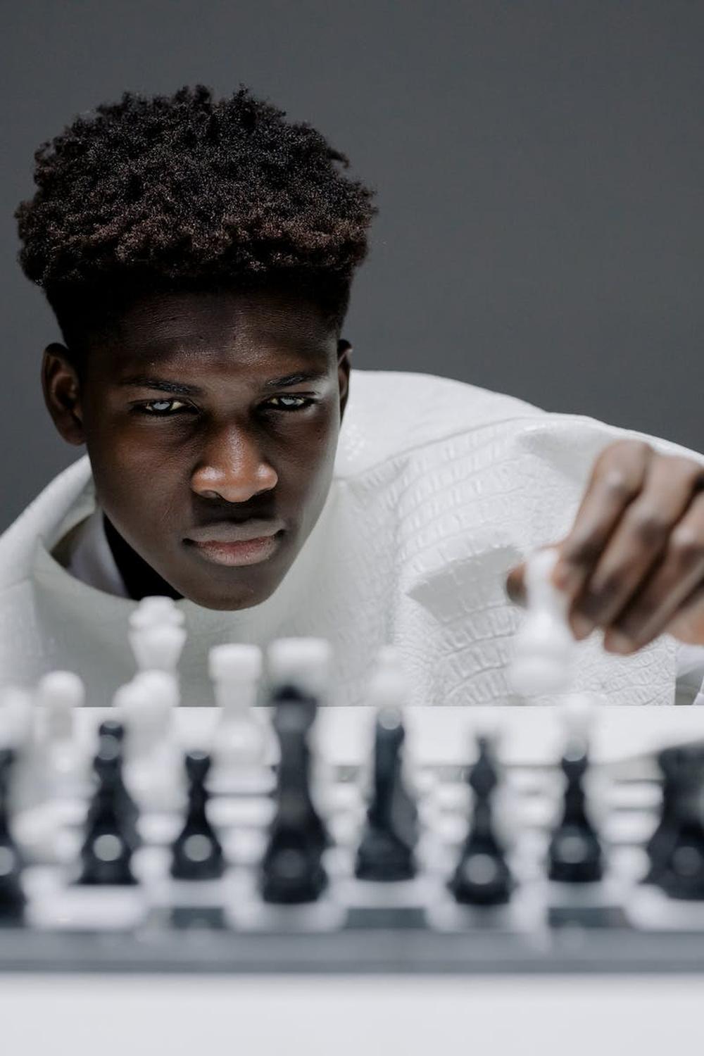 man_in_white_long_sleeve_shirt_playing_chess