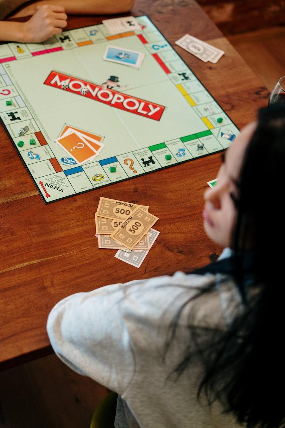 monopoly_board_game_on_brown_wooden_table_top