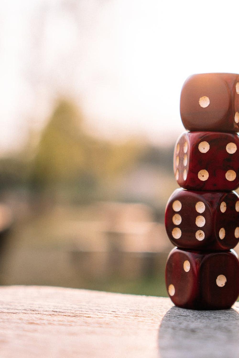 red_dice_stacked_on_table_on_terrace