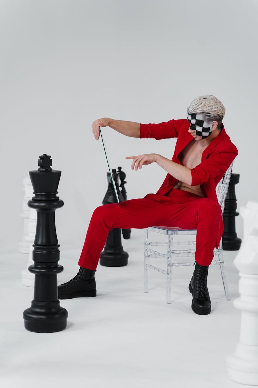 stylish_man_in_red_suit_beside_chess_pieces