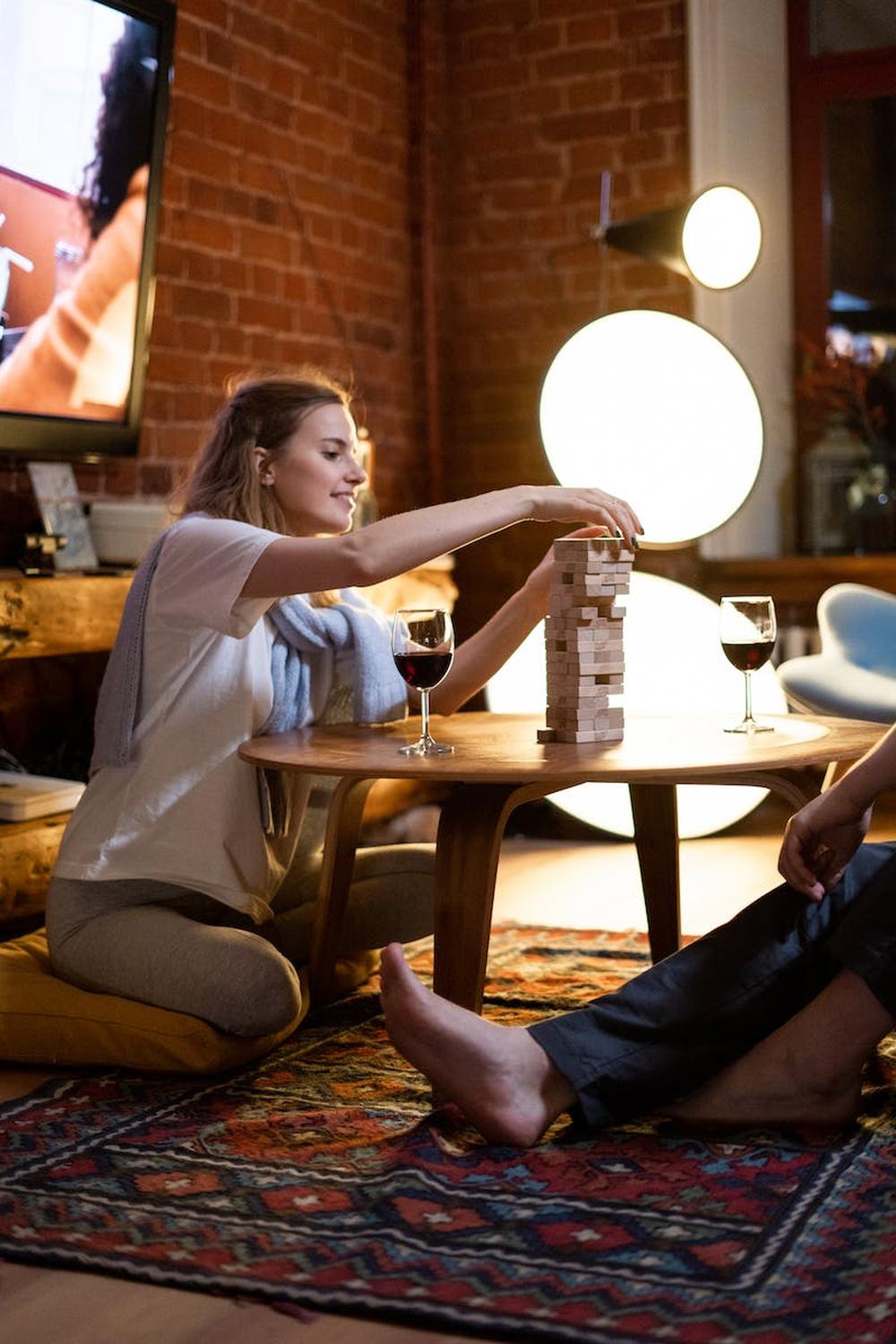 woman_in_white_long_sleeve_shirt_sitting_on_brown_